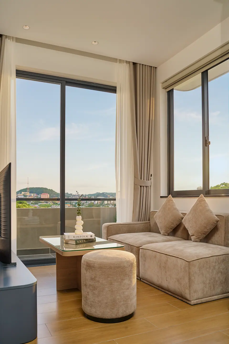 Sofa by floor-to-ceiling windows looking over the city