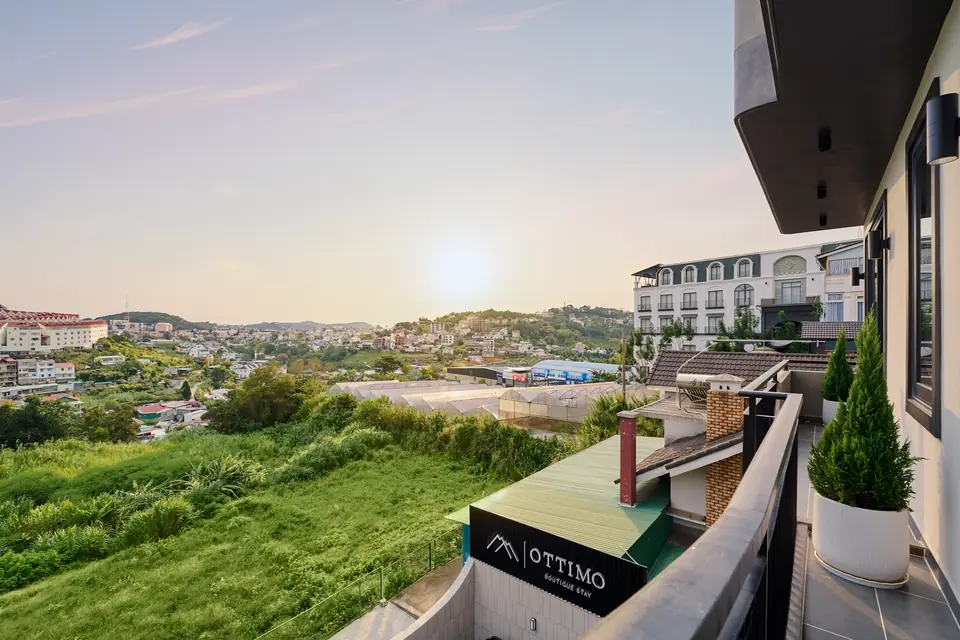 Private balcony looking over green slopes at sunset
