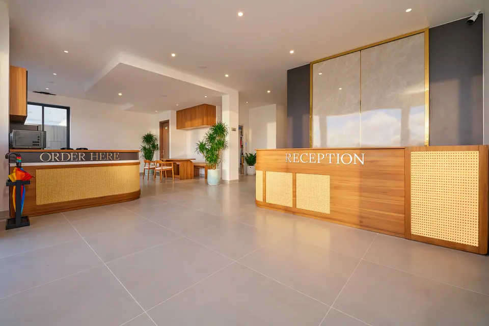 Ground-floor lobby with an oak reception desk and a coffee counter