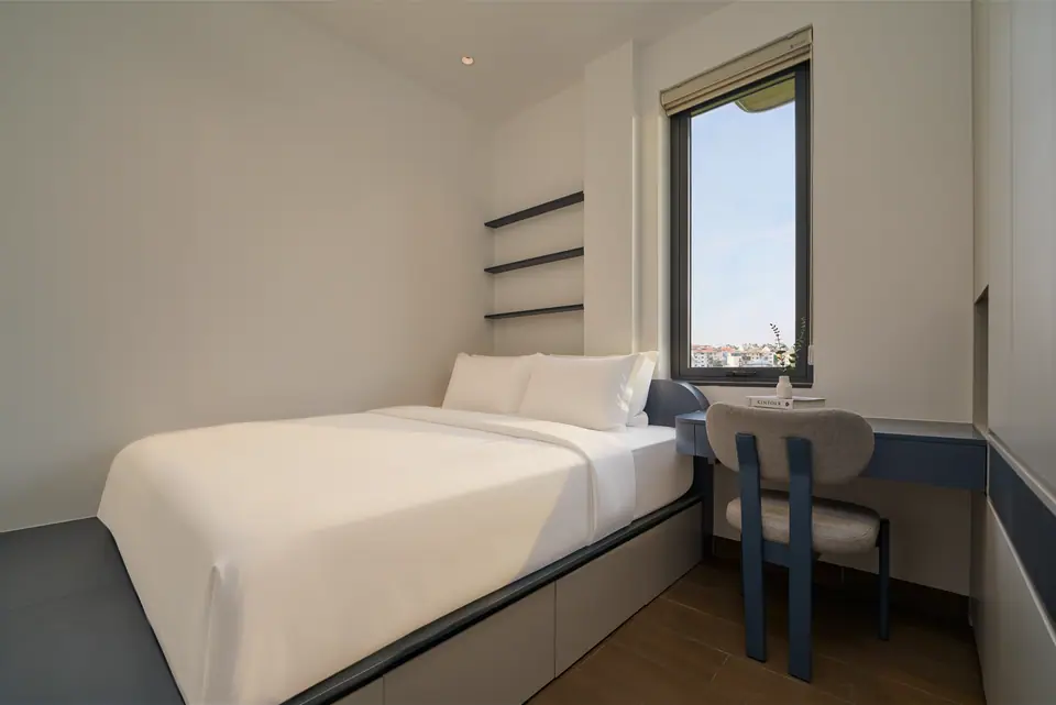 Separate bedroom with a double bed and a desk by the window